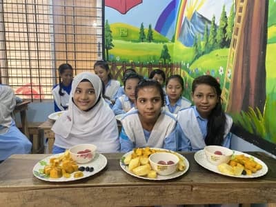 Underprivileged students engaged in classroom learning with educational supplies and textbooks